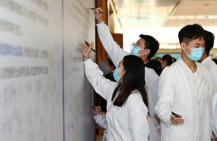 2020年“全国安全用药月”陕西启动仪式现场，医疗机构工作人员在承诺墙上签字（赵光 摄）