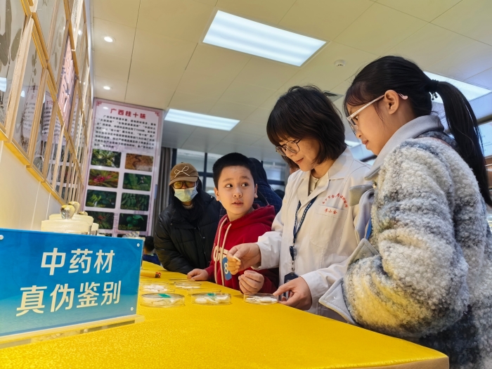 图为检验人员为孩子们讲解中药材知识。（何正君 摄）